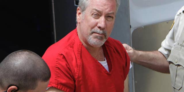 FILE - In this May 8, 2009 file photo, former Bolingbrook, Ill., police officer Drew Peterson arrives for court in Joliet, Ill. On Tuesday, April 14, 2015, a Randolph County judge in Chester, Ill., set a July 6, 2015 jury trial date for Peterson, who is charged with trying to kill the prosecutor who helped put him in prison for his third wife's death. (AP Photo/M. Spencer Green, File)