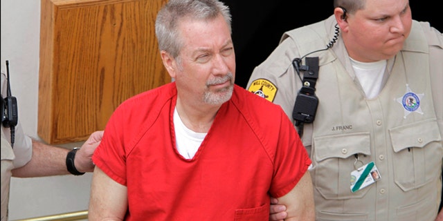 May 8, 2009: File photo, former Bolingbrook, Ill., police sergeant Drew Peterson leaves the Will County Courthouse in Joliet, Ill., after his arraignment on charges of first-degree murder in the 2004 death of his former wife Kathleen Savio.