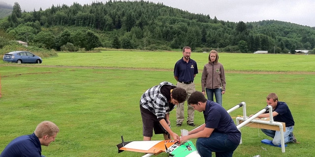 July 26, 2012: This photo provided by Embry-Riddle Aeronautical University shows students demonstrating the launch catapult for their drone aircraft near Tillamook, Ore.