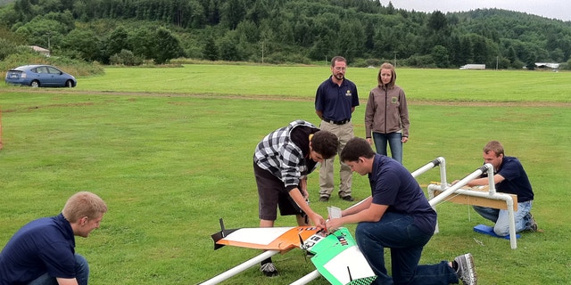 July 26, 2012: This photo provided by Embry-Riddle Aeronautical University shows students demonstrating the launch catapult for their drone aircraft near Tillamook, Ore.