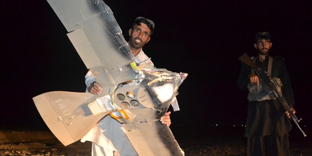 Aug. 25: A Pakistani villager holds a wreckage of a suspected surveillance drone that crashed in Pakistani border town of Chaman along the Afghanistan border.
