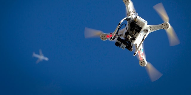 File photo - An airplane flies over a drone during the Polar Bear Plunge on Coney Island in the Brooklyn borough of New York Jan. 1, 2015.