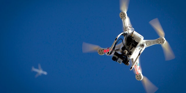 File photo - An airplane flies over a drone during the Polar Bear Plunge on Coney Island in the Brooklyn borough of New York Jan. 1, 2015.