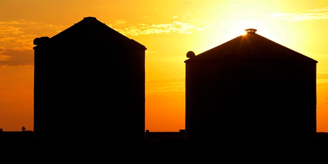 July 22, 2012: The sun rises over grain silos in Ashland, Ill.
