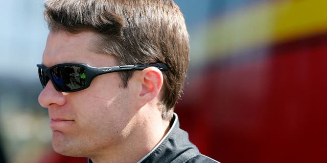 DAYTONA BEACH, FL - FEBRUARY 20: David Ragan, driver of the #23 Dr Pepper Toyota, stands in the garage area during practice for the NASCAR Sprint Cup Series Daytona 500 at Daytona International Speedway on February 20, 2016 in Daytona Beach, Florida. (Photo by Brian Lawdermilk/Getty Images)