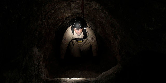A U.S. Immigration and Customs Enforcement agent climbs in a drug tunnel in San Diego on Dec. 2, 2010. Tunnels are a commonly used method to transport drugs from Mexico to the U.S.