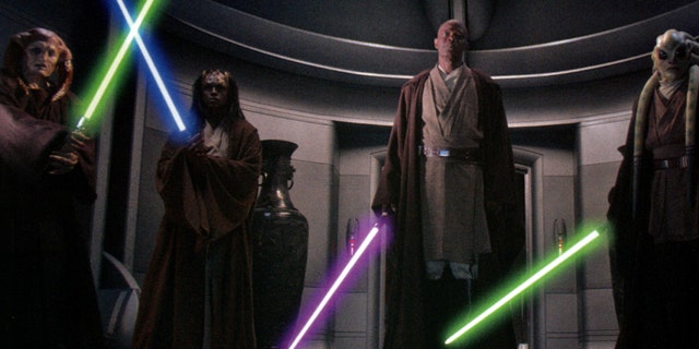 Saesee Tiin, Agen Kolar, Mace Windu, and Kit Fisto ignite their lightsabers to arrest Supreme Chancellor Palpatine in Star Wars Episode III: Revenge of the Sith.