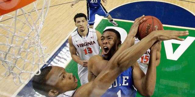 FILE - In this March 16, 2014 file photo, Duke's Jabari Parker (1) tries to shoot over Virginia's Darion Atkins during the first half of an NCAA college basketball game in the championship of the Atlantic Coast Conference tournament in Greensboro, N.C. Parker says he plans to meet with Duke coach Mike Krzyzewski when he returns to Durham, N.C., on Tuesday, April 15, 2014, and he will decide Wednesday whether to declare for the NBA draft or return to college for his sophomore year. (AP Photo/Bob Leverone, File)