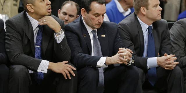 Duke head coach Mike Krzyzewski, center, and assistant coaches Jeff Capel, left, and Steve Wojciechowski, right, watch the final minute of an NCAA college basketball game against Wake Forest in Winston-Salem, N.C., Wednesday, March 5, 2014. Wake Forest won 82-72. (AP Photo/Chuck Burton)