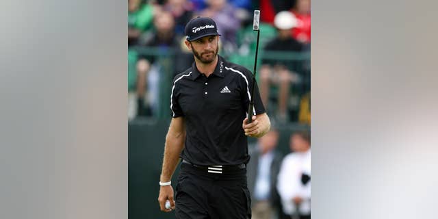 FILE - In this July 19, 2014, file photo,Dustin Johnson acknowledges the gallery after holing his putt on the first green during the third day of the British Open Golf championship at the Royal Liverpool golf club, Hoylake, England. Johnson says in a magazine interview that cocaine is not the reason he chose to sit out the last six months to get his life in order. Johnson said in August that he was taking a leave of absence from the PGA Tour to seek professional help for what he called "personal challenges." (AP Photo/Jon Super, File)