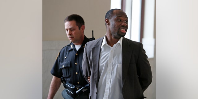 April 16, 2013: This photo in Cincinnati shows Ricardo Woods being taken from court after he was found guilty in the shooting death of a man who authorities say identified his assailant by blinking his eyes while paralyzed.