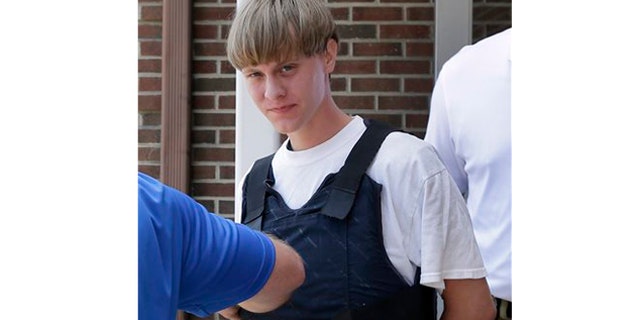 June 18: Charleston, S.C., shooting suspect Dylann Storm Roof is escorted from the Sheby Police Department in Shelby, N.C.