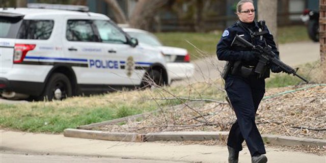 CORRECTS SPELLING OF LAST NAME TO LANE INSTEAD OF LYNE - Longmont Police arrive at the scene of a stabbing on Wednesday, March 18, 2015 in Longmont, Colo. Dynel Lane, 34, is accused of stabbing a pregnant woman in the stomach and removing her baby, while the expectant mother visited her home to buy baby clothes advertised on Craigslist authorities said. The 26-year-old expectant mother was found beaten and stabbed at the suspect's home. The expectant mother has undergone surgery, and on Thursday was alert, police said. The baby did not survive. (AP Photo/The Daily Times Call, Matthew Jonas) NO SALES