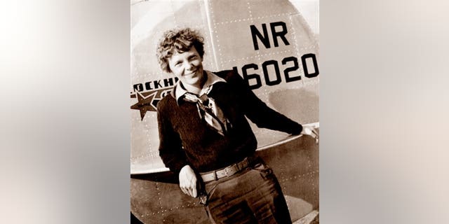 This May 20, 1937 photo, provided by The Paragon Agency, shows aviator Amelia Earhart at the tail of her Electra plane, taken at Burbank Airport in Burbank, Calif. (Albert Bresnik/The Paragon Agency via AP)