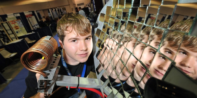 May 16, 2011: Seth Fisher, 16, from Bernville, Pa., demonstrates his solar heat concentrator at the Intel International Science and Engineering Fair, the world’s largest pre-college science competition, in Reno, Nev.