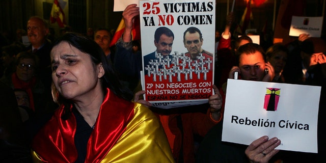 A woman wears the Spanish flag during a protest in front of the Town Hall against the house arrest granted to the hunger striking prisoner Inaki de Juana Chaos on March 2, 2007 in Madrid, Spain. (Photo by Denis Doyle/Getty Images)