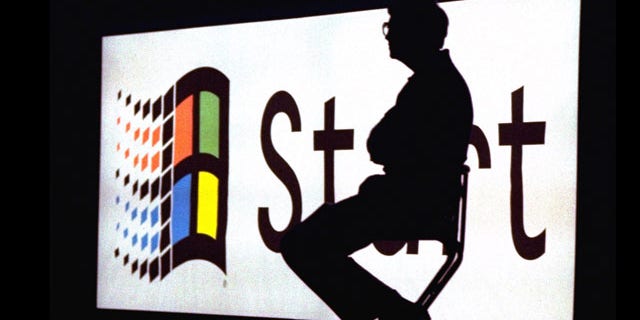 Microsoft Chairman Bill Gates sitting on stage during a video portion of the Windows 95 Launch Event, on the company's campus in Redmond, Washington.