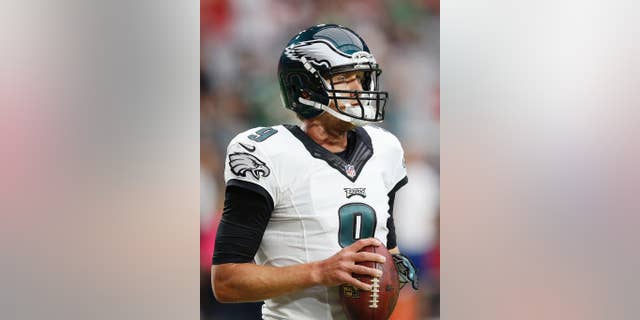 Philadelphia Eagles' Nick Foles holds the football as his team warms up prior to an NFL football game against the Arizona Cardinals, Sunday, Oct. 26, 2014, in Glendale, Ariz. (AP Photo/Ross D. Franklin)