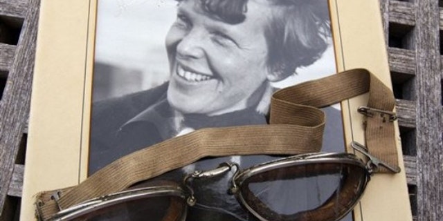 Sept. 9, 2011: An original, unpublished personal photo of Amelia Earhart dated 1937, along with goggles she was wearing during her first plane crash are seen at Clars Auction Gallery in Oakland, Calif. Another set of her goggles sold several years ago for more than $100,000.