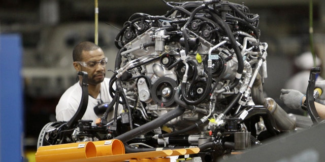 FILE - In this April 28, 2011 file photo, an assemblyman works on an engine for the Chrysler Jeep or the Dodge Durango which are built on the same line at Chrysler's Jefferson North Assembly Plant in Detroit. The company reported first-quarter net income of $116 million and revenues of $13.1 billion on Monday, May 2, 2011. The profit is a milestone in Chrysler's long road back to health after its 2009 bankruptcy. It last reported a profit in 2007. (AP Photo/Carlos Osorio)