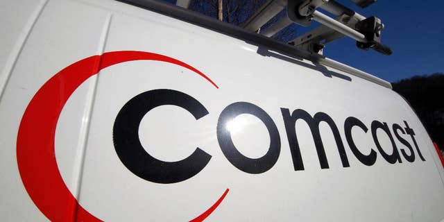 FILE - This Feb. 11, 2011 file photo shows the Comcast logo on one of the company's vehicles, in Pittsburgh. Comcast reports quarterly earnings on Tuesday, April 22, 2014. (AP Photo/Gene J. Puskar, File)