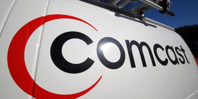 FILE - This Feb. 11, 2011 file photo shows the Comcast logo on one of the company's vehicles, in Pittsburgh. Comcast reports quarterly earnings on Tuesday, April 22, 2014. (AP Photo/Gene J. Puskar, File)