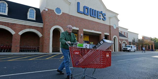 FILE - In this Nov. 18, 2014 file photo, a customer leaves a Lowe's home improvement store in Charlotte, N.C. Lowe's Companies Inc. reports quarterly financial results before the market opens Wednesday, May 20, 2015. (AP Photo/Chuck Burton, File)