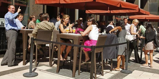 People have drinks at an outdoor cafe on L Street NW in Washington, Tuesday, Aug. 23, 2011, after an earthquake hit the Washington area, evacuating buildings. (AP Photo/Jacquelyn Martin)
