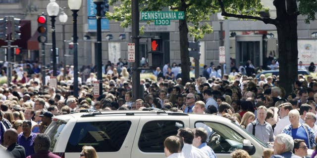People crowd Pennsylvania Avenue in Washington, Tuesday, Aug. 23, 2011, as buildings were evacuated following an earthquake. (AP Photo/Charles Dharapak)