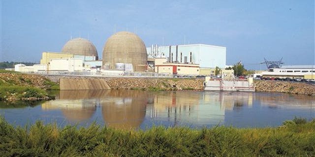 In this Feb. 10, 2005 file photo, The containment domes enclosing the North Anna Power Station's two nuclear reactors rise over a discharge canal at the Louisa plant in Spotsylvainia county Va.