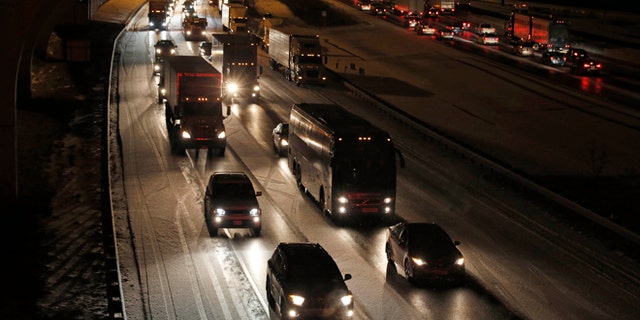 Traffic is bumper to bumper and mostly at a stand-still on the outer loop of the I-495 Capital Beltway after snow fell Wednesday, Jan. 20, 2016, in National Harbor, Md. As Washington prepares for this weekend's snowstorm, now forecast to reach blizzard conditions, a small clipper system pushed through the region Wednesday night causing massive delays and issues on the roads. (AP Photo/Alex Brandon)