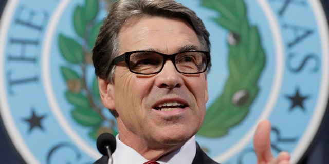 In this Friday, Oct. 17, 2014 photo, Texas Gov. Rick Perry answers questions during a news conference to discuss Texas Ebola prevention efforts in Austin, Texas.