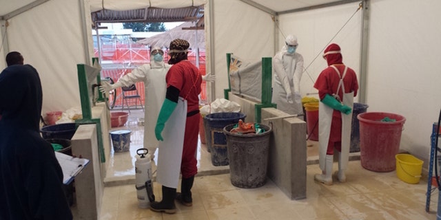 Health care workers prepare to treat patients with Ebola virus at a treatment center in West Africa.