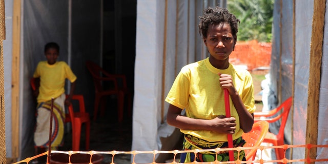 Rose Komono poses for a picture at a health clinic after overcoming the Ebola virus in Gueckedou April 3, 2014. (REUTERS/Misha Hussain)