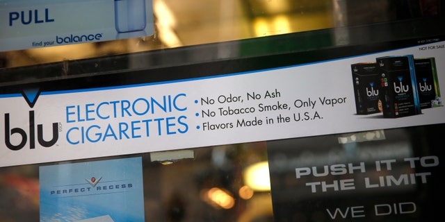 May 27, 2014: An advertisement for the e-cigarette brand blu is seen in the window of a store in New York.