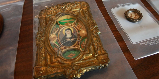 CHICAGO - JUNE 08: Religious relics which were among the approximately 1,600 artifacts which the Federal Bureau of Investigation (FBI) says were stolen from the Italian government by collectibles dealer John Sisto are displayed at a news conference at the Chicago offices of the bureau June 8, 2009 in Chicago, Illinois. The artifacts, discovered inside the Berwyn, Illinois home of Sisto following his death in 2007, are being returned to Italy. Included are letters written by former kings and popes, books, some handwritten, dating to the 1700s, and other religious and political artifacts. The value of the items is estimated at $5 to $10 million. (Photo by Scott Olson/Getty Images)