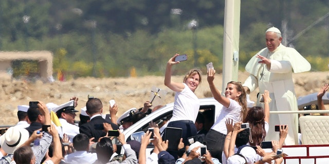 July 6, 2015 - Pope Francis waves to the crowd as he rides in the popemobile through Samanes Park, where he celebrated Mass, in Guayaquil, Ecuador.
