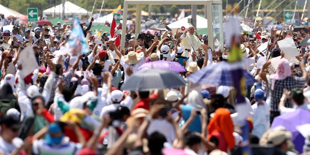 July 6, 2015 - Pope Francis aboard the popemobile after arriving in Samanes Park to celebrate Mass, in Guayaquil, Ecuador. Many in the crowd of hundreds of thousands had spent the night and walked for miles to celebrate Mass with the pontiff.