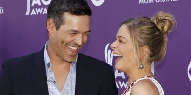 LeAnn Rimes, right, and Eddie Cibrian arrive at the 47th Annual Academy of Country Music Awards on Sunday, April 1, 2012 in Las Vegas. (AP Photo/Isaac Brekken)
