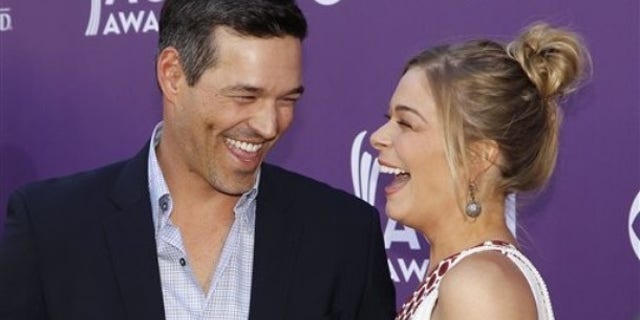LeAnn Rimes, right, and Eddie Cibrian arrive at the 47th Annual Academy of Country Music Awards on Sunday, April 1, 2012 in Las Vegas. (AP Photo/Isaac Brekken)