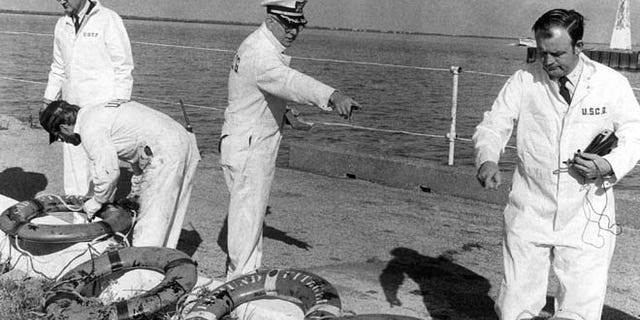 FILE 1975: Coast Guard officers on a Board of Inquiry inspected life rings that were recovered from the ore carrier Edmund Fitzgerald, which sank in stormy weather in Lake Superior on Nov. 10, 1975.