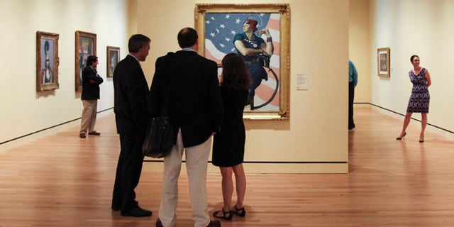 FILE 2012: Guests observe Norman Rockwell's 1943 oil on canvas painting "Rosie the Riveter" in Bentonville, Arkansas.
