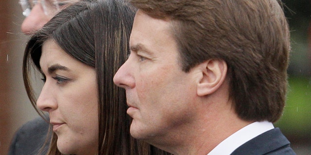 Cate Edwards and her father John Edwards watch as the casket containing the body of Elizabeth Edwards is loaded into the hearse following funeral services in Raleigh, N.C.