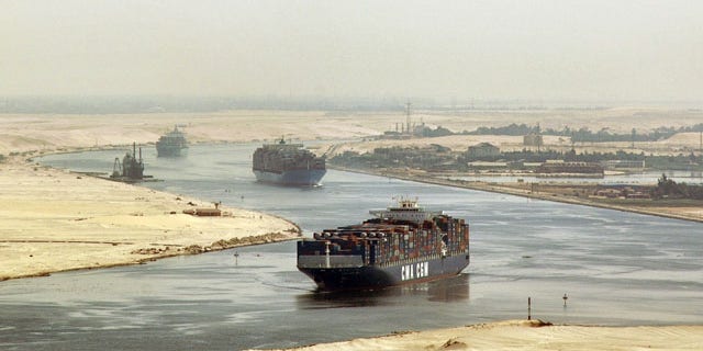 In this Sept. 21, 2009 file photo, cargo ships sail through the Suez Canal, seen from a helicopter, near Ismailia, Egypt. Egypt has agreed to allow two Iranian naval vessels to transit the Suez Canal to the Mediterranean.
