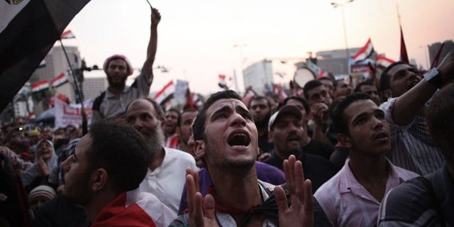 June 23, 2012: Egyptian protesters shout slogans in Tahrir Square as the country awaits the outcome of a presidential runoff vote.