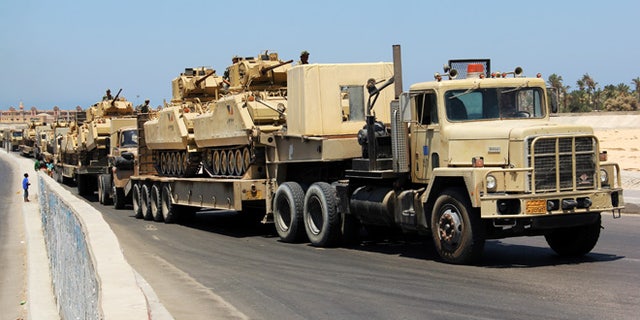 Aug. 9. 2012: In this file photo, army trucks carry Egyptian military tanks in El Arish, Egypt's northern Sinai Peninsula.