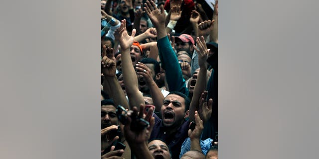 Egyptian protesters chant slogans during a protest at Tahrir Square in Cairo, Egypt ,Friday, May 27, 2011. Thousands of protesters poured into downtown Cairo's Tahrir Square Friday for what they called a "second revolution," striking harsh tone against Egypt's military rulers, and say "Egyptians' revolution is not over."