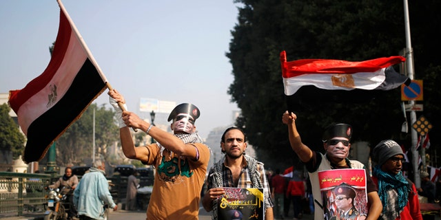 Saturday, Jan. 25, 2014: Egyptians wear masks of Defense Minister Gen. Abdel-Fattah el-Sissi, in Tahrir Square, in Cairo, Egypt.