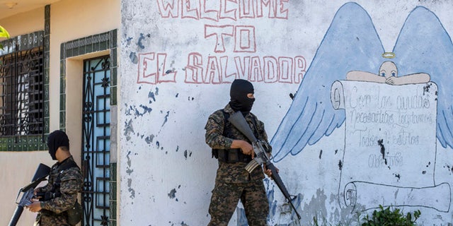 FILE - In this Aug. 31, 2015 file photo, soldiers guard a corner in a gang-controlled neighborhood in Ilopango, El Salvador. A video broadcast by local media on Saturday, March 26, 2016, purportedly made by the countryâs main street gangs, is offering an end to killings, and asks the government not to continue an anti-gang offensive. Officials said they would not negotiate with the gangs. (AP Photo/Salvador Melendez, File)