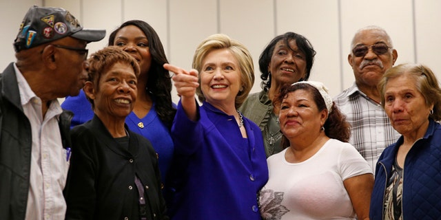FILE - In this Monday, June 6, 2016 file photo, Democratic presidential candidate Hillary Clinton, center, visits a community center, Monday, June 6, 2016, in Compton, Calif. State officials are preparing to embrace an expanded California electorate Tuesday as nearly 18 million registered voters head for the polls or turn in early presidential primary ballots. (AP Photo/John Locher, File)